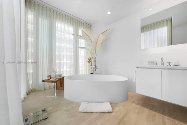 a spacious bathroom with a bathtub and shower