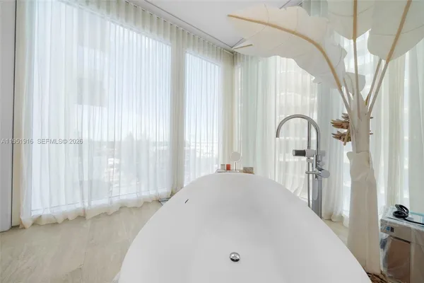 a en suite bathroom with a tub and mirror