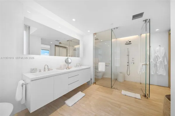 a bathroom with a tub sink mirror and toilet