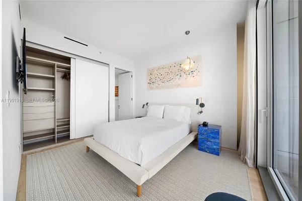 a bedroom with a bed and a walk in closet