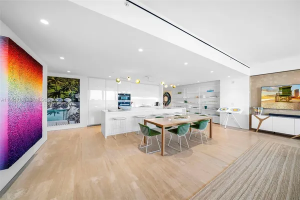 a large kitchen with a table and chairs in it