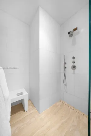 a bathroom with a toilet and a shower