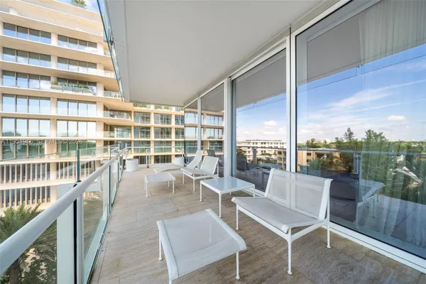 a view of a balcony with chairs
