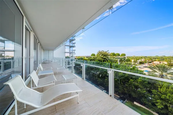 a view of balcony with couches and wooden floor
