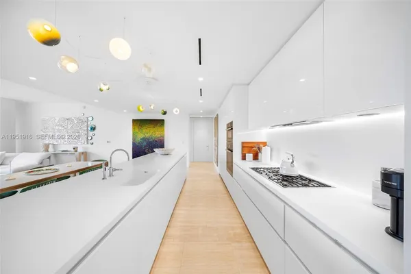 a large kitchen with stainless steel appliances kitchen island granite countertop a sink and cabinets