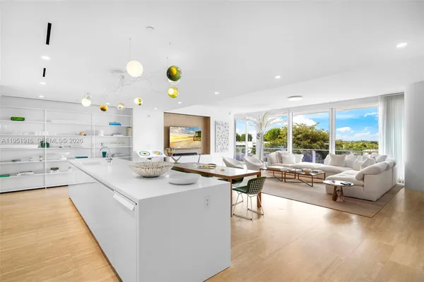 a kitchen with a sink and living room view