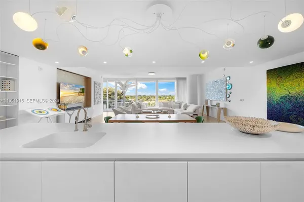 a kitchen with a sink and chairs