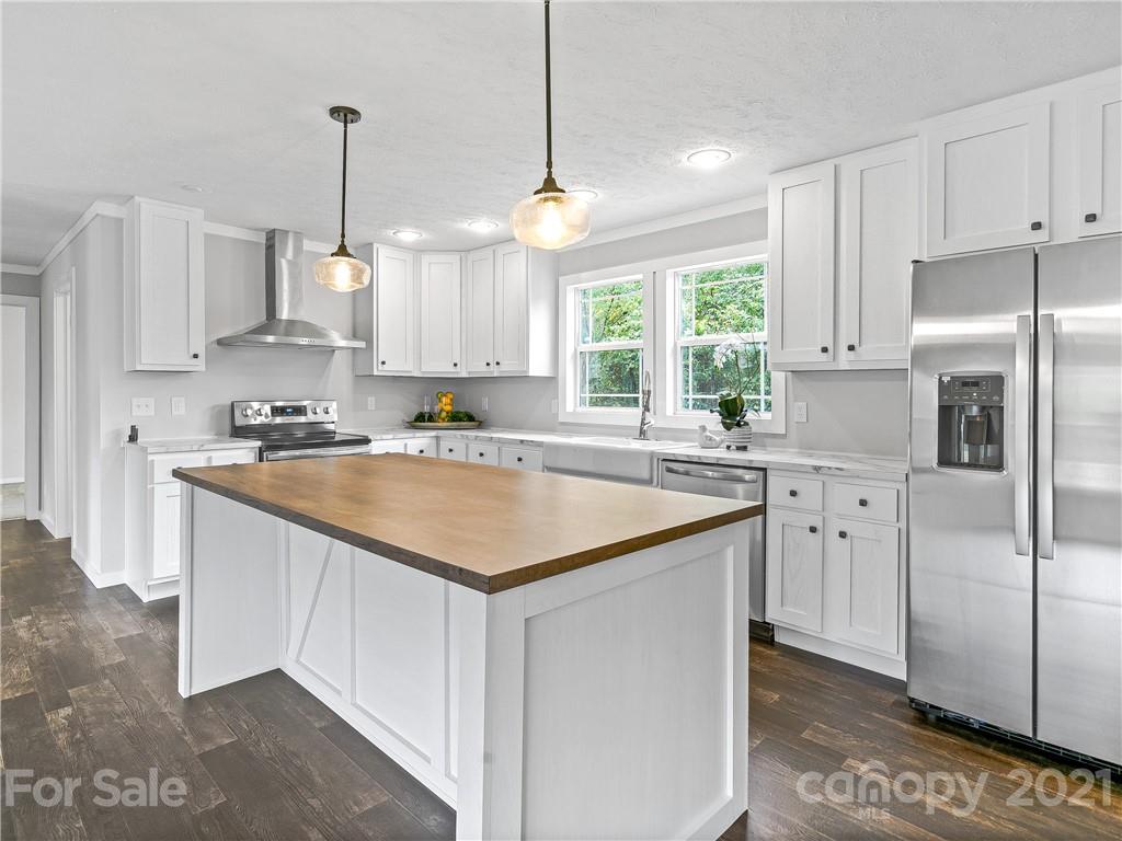 14 Souther Road Fletcher, NC 28732 - Photo 11 of 25 a kitchen with stainless steel appliances granite countertop a sink a stove a refrigerator a center island and cabinets