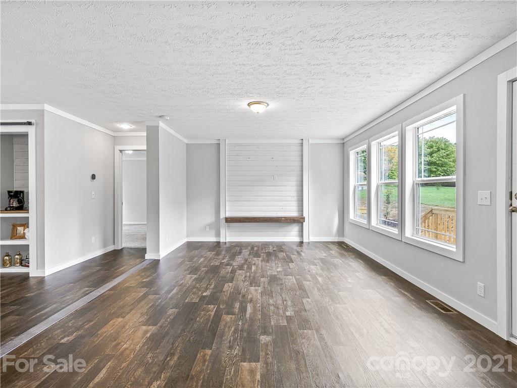 14 Souther Road Fletcher, NC 28732 - Photo 3 of 25 a view of an empty room with wooden floor and a window
