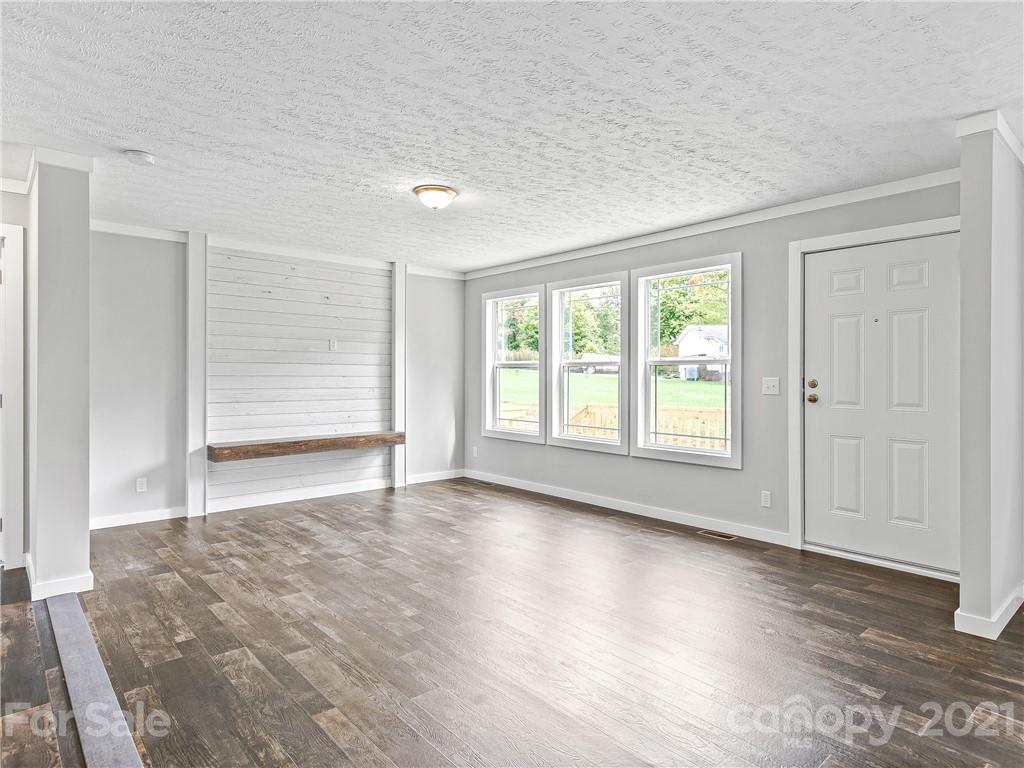 14 Souther Road Fletcher, NC 28732 - Photo 4 of 25 a view of an empty room with wooden floor and a window