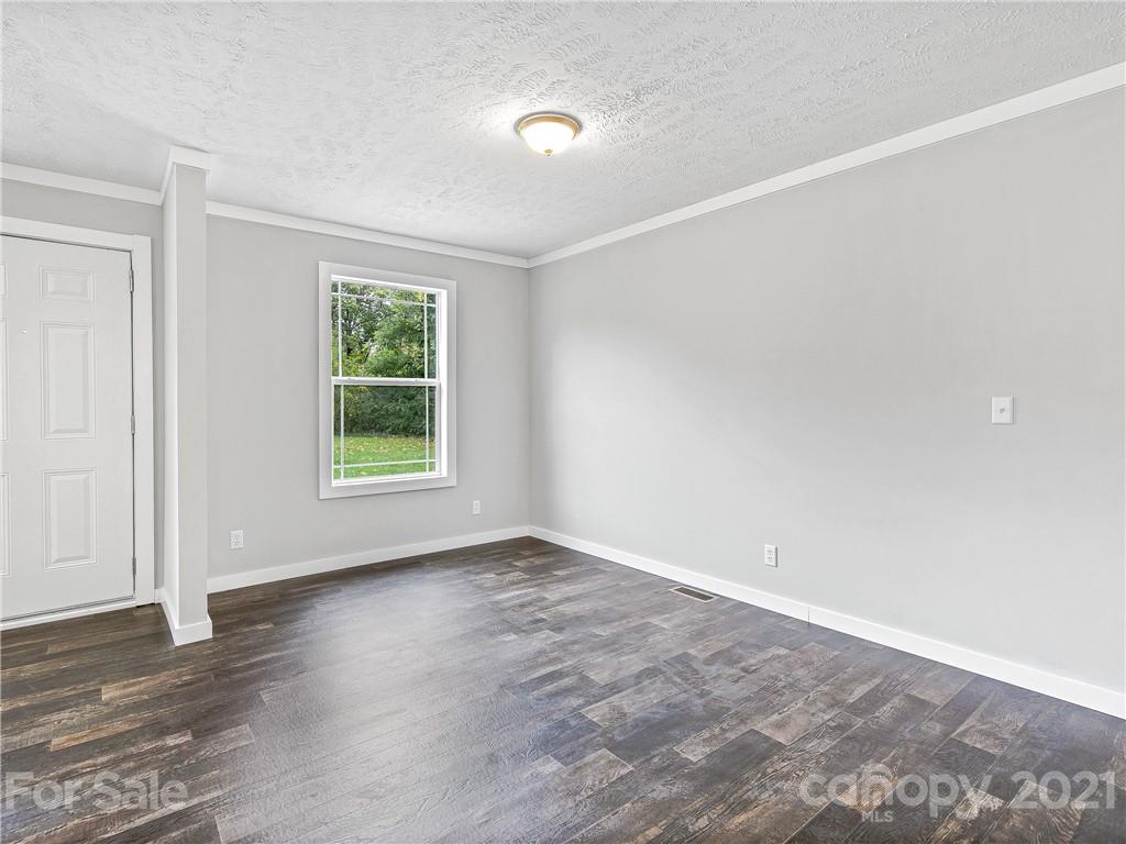 14 Souther Road Fletcher, NC 28732 - Photo 5 of 25 an empty room with wooden floor and windows