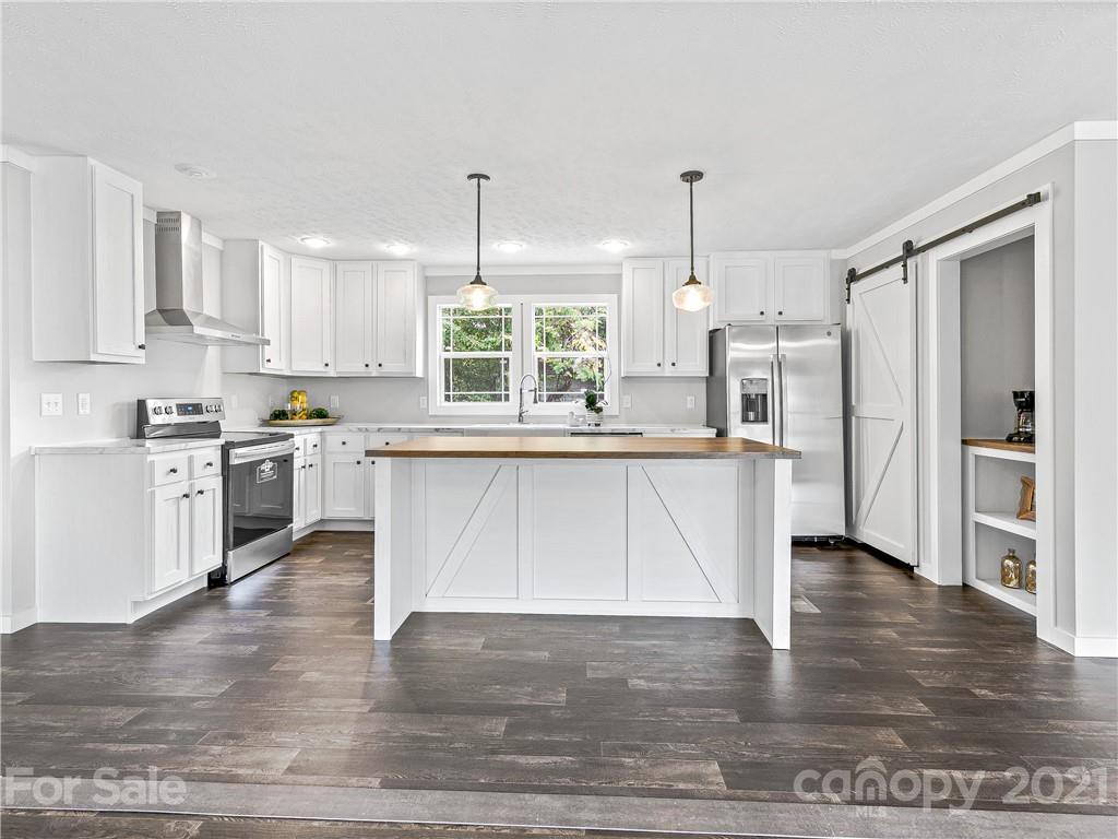 14 Souther Road Fletcher, NC 28732 - Photo 6 of 25 a large kitchen with stainless steel appliances granite countertop a stove a sink dishwasher and a refrigerator with wooden floor