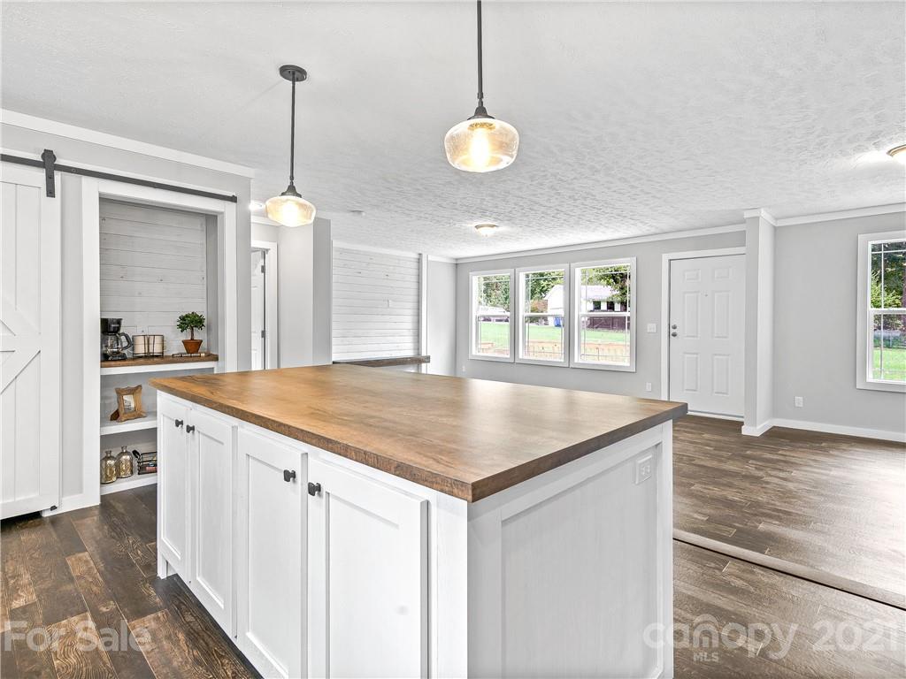 14 Souther Road Fletcher, NC 28732 - Photo 8 of 25 a kitchen with kitchen island a counter space a sink and appliances