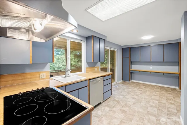 a kitchen with stainless steel appliances granite countertop a stove and a sink with granite countertops