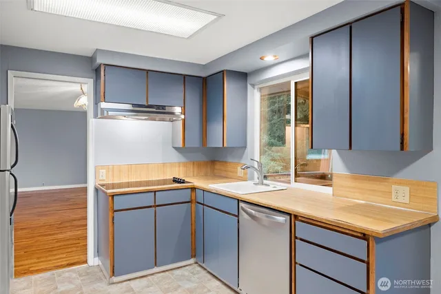 a kitchen with a sink stove and cabinets