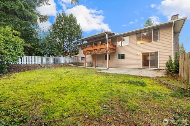 a view of a backyard with large trees
