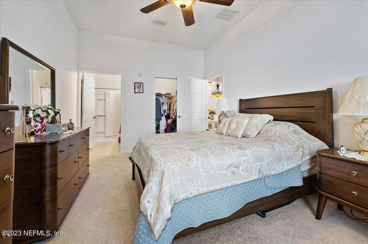 605 Golden Lake Loop St. Augustine, FL 32084 - Photo 11 of 20 a bedroom with a bed and dresser