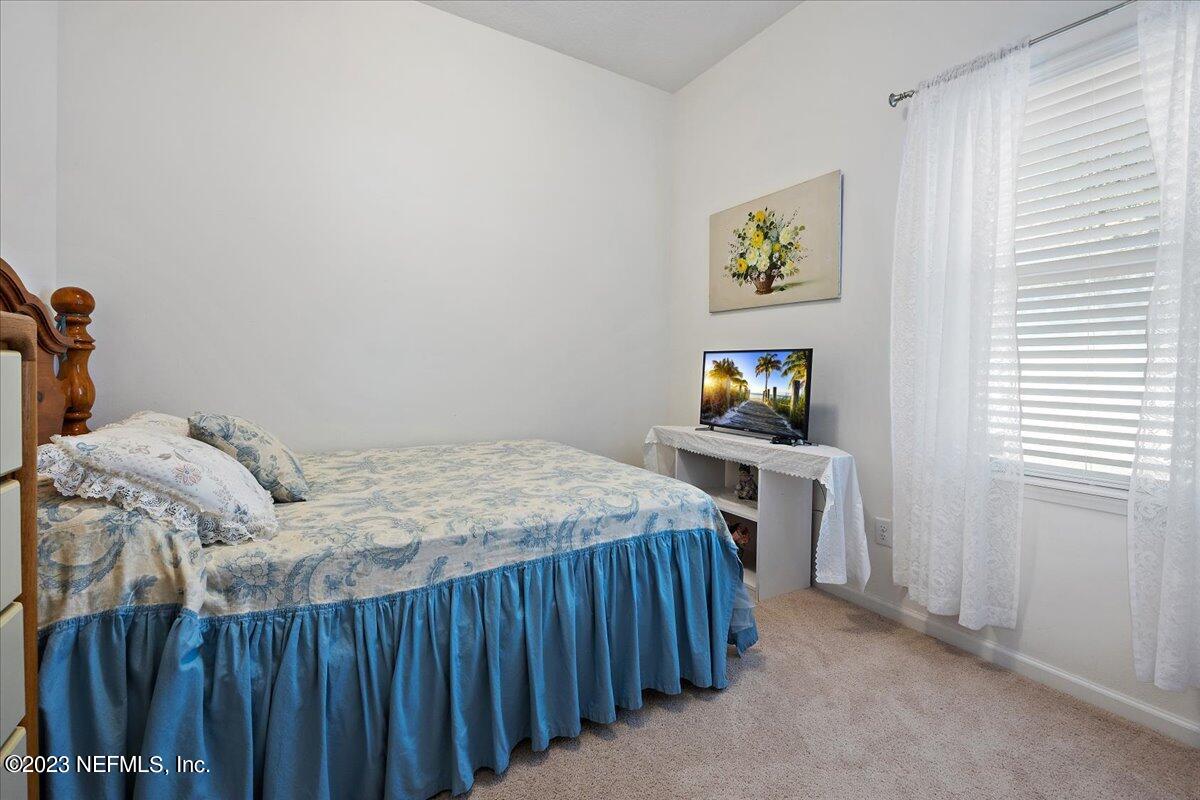 605 Golden Lake Loop St. Augustine, FL 32084 - Photo 15 of 20 a bedroom with a bed and painting on the wall