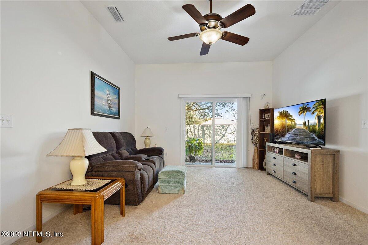605 Golden Lake Loop St. Augustine, FL 32084 - Photo 6 of 20 a living room with furniture and a flat screen tv