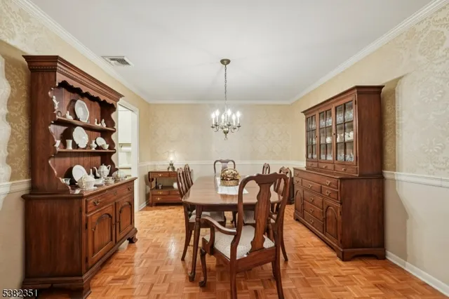 a view of a dining room with furniture and chandelier