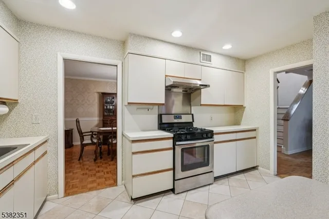 a kitchen with a stove and a refrigerator