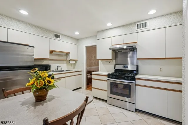 a kitchen with a sink stainless steel appliances and cabinets