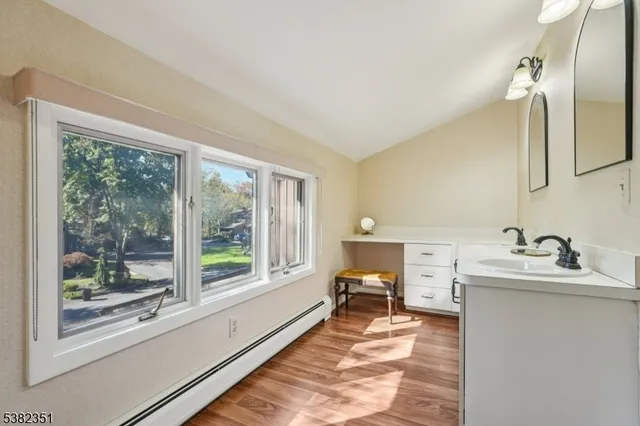 a spacious bathroom with a double vanity sink and a large mirror