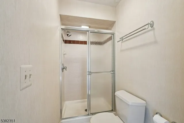 a bathroom with a shower a toilet and a shower