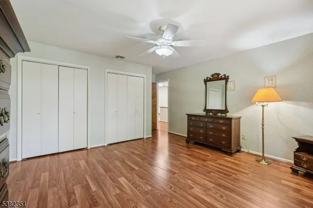 a view of a room with wooden floor closet and a bathroom