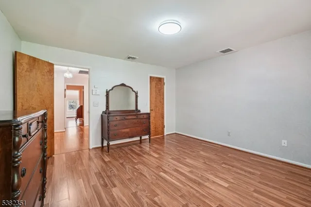 a view of living room with furniture and wooden floor