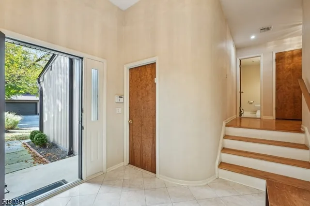 a view of entryway with wooden floor and a living room