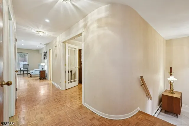 a view of a hallway with workspace and a living room