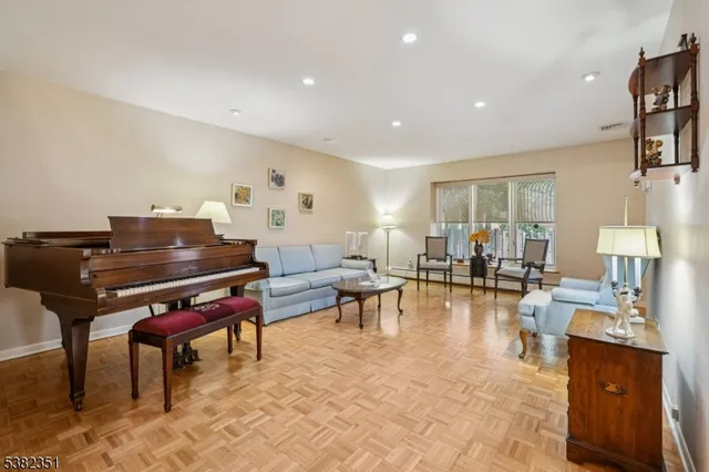 a living room with furniture a piano and a piano