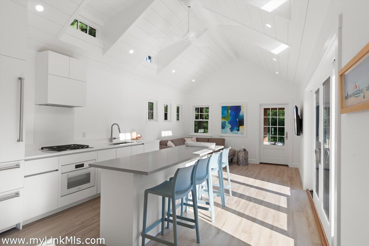 3 Tautemo Way Nantucket, MA 02554 - Photo 47 of 57 a kitchen with stainless steel appliances granite countertop a stove top oven a sink a dining table and chairs