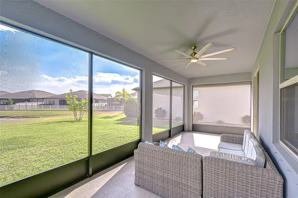 a spacious bedroom with a large window and a balcony