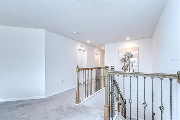 a bathroom with a granite countertop toilet sink and mirror