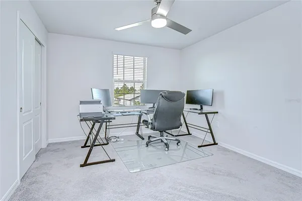 a bedroom with a bed a window and a flat screen tv