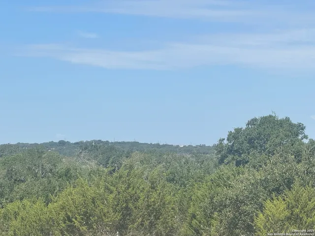a view of a large mountain with mountains in the background