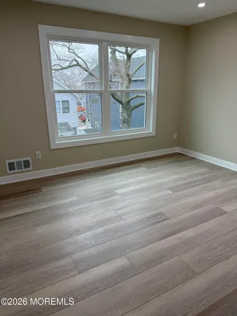 a view of lot of window and wooden floor