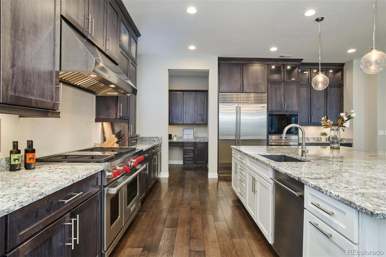 4907 Hogback Ridge Road Morrison, CO 80465 - Photo 13 of 40 a kitchen with granite countertop a sink stainless steel appliances and cabinets