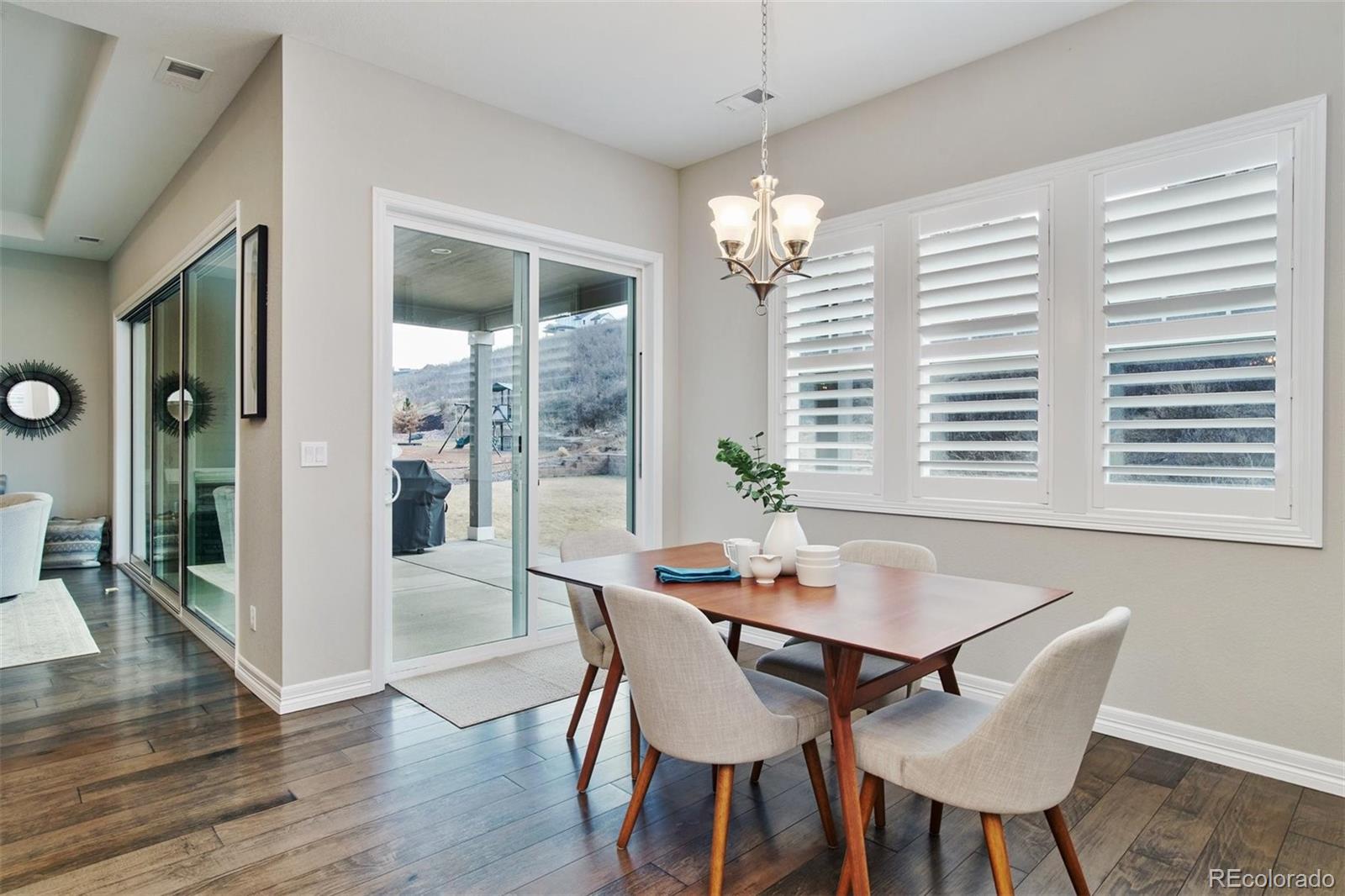 4907 Hogback Ridge Road Morrison, CO 80465 - Photo 14 of 40 a view of a dining room with furniture wooden floor and chandelier