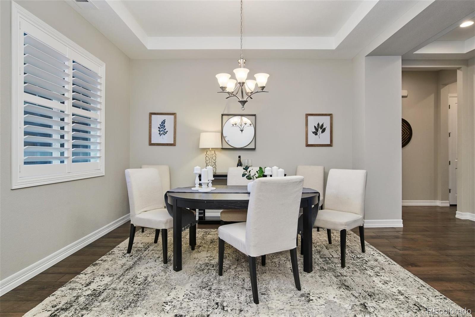 4907 Hogback Ridge Road Morrison, CO 80465 - Photo 16 of 40 a view of a dining room with furniture a rug and wooden floor