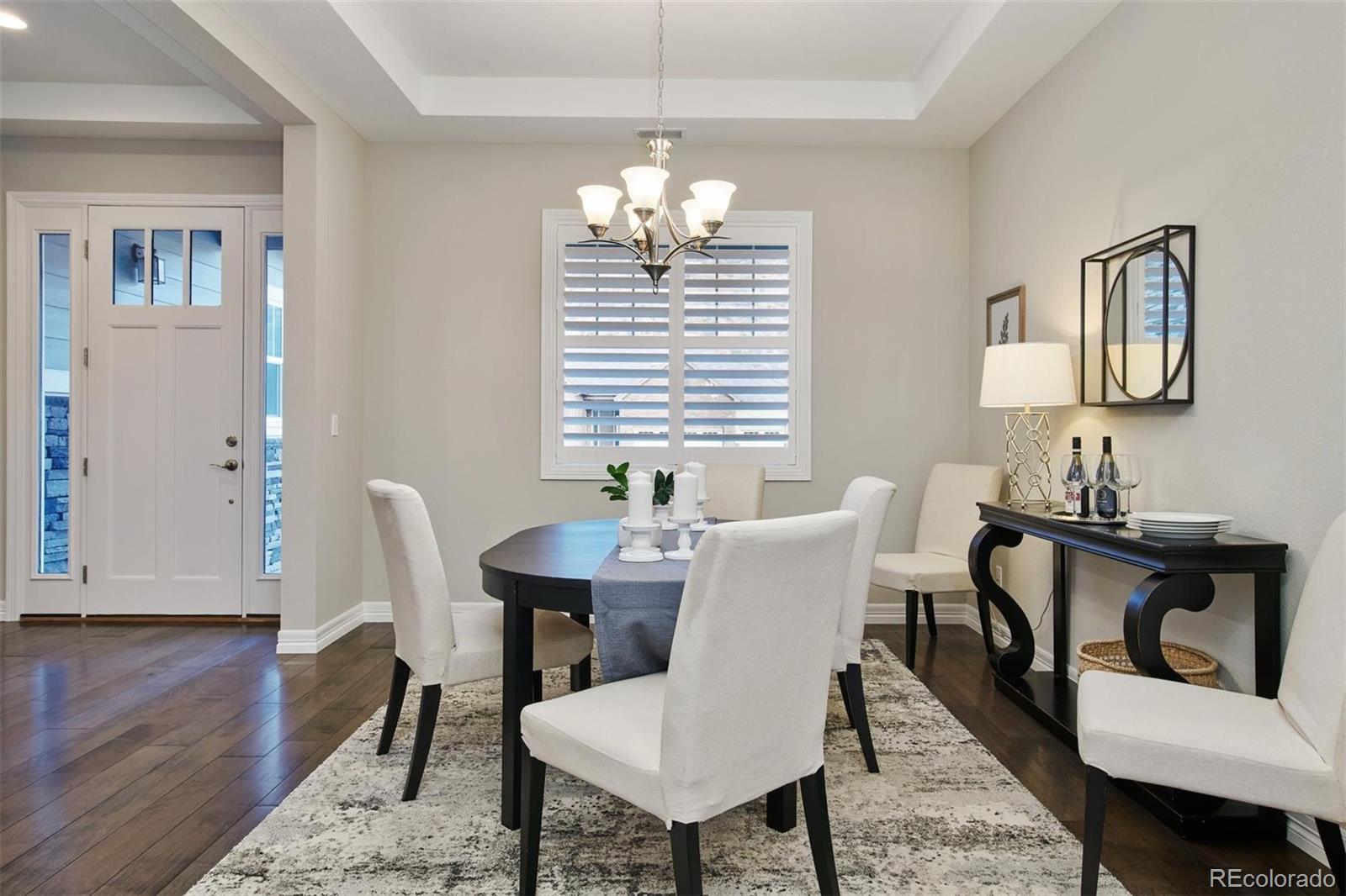 4907 Hogback Ridge Road Morrison, CO 80465 - Photo 17 of 40 a view of a dining room with furniture window and wooden floor