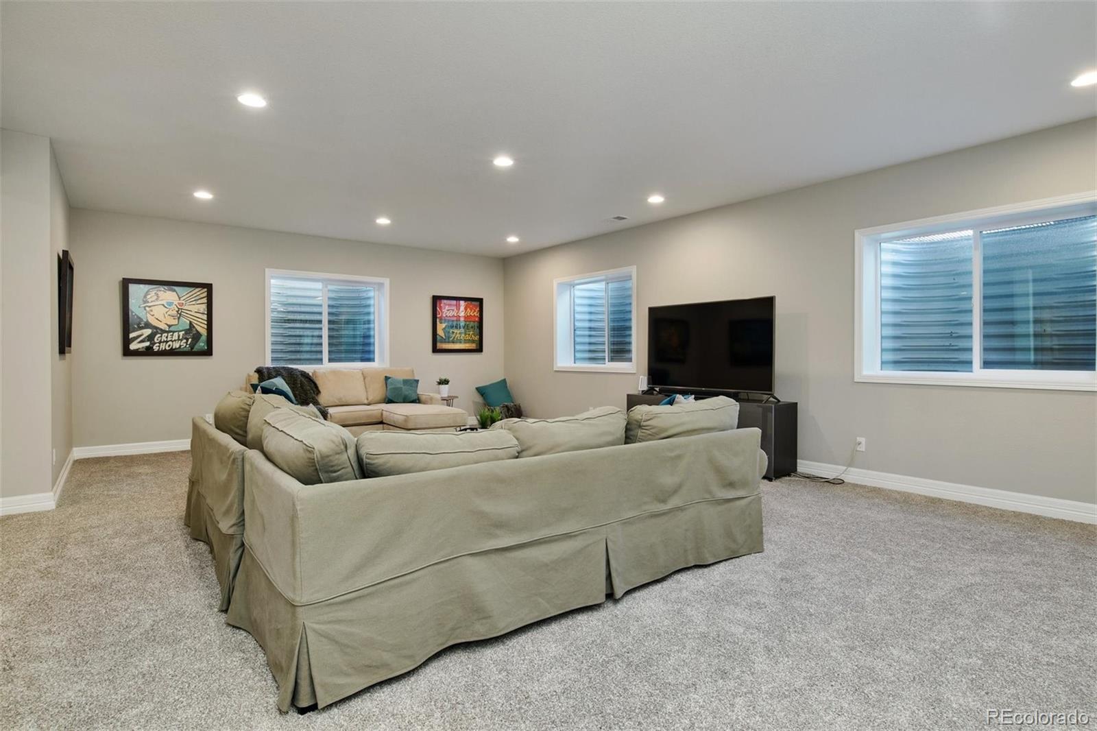4907 Hogback Ridge Road Morrison, CO 80465 - Photo 27 of 40 a living room with furniture and a flat screen tv