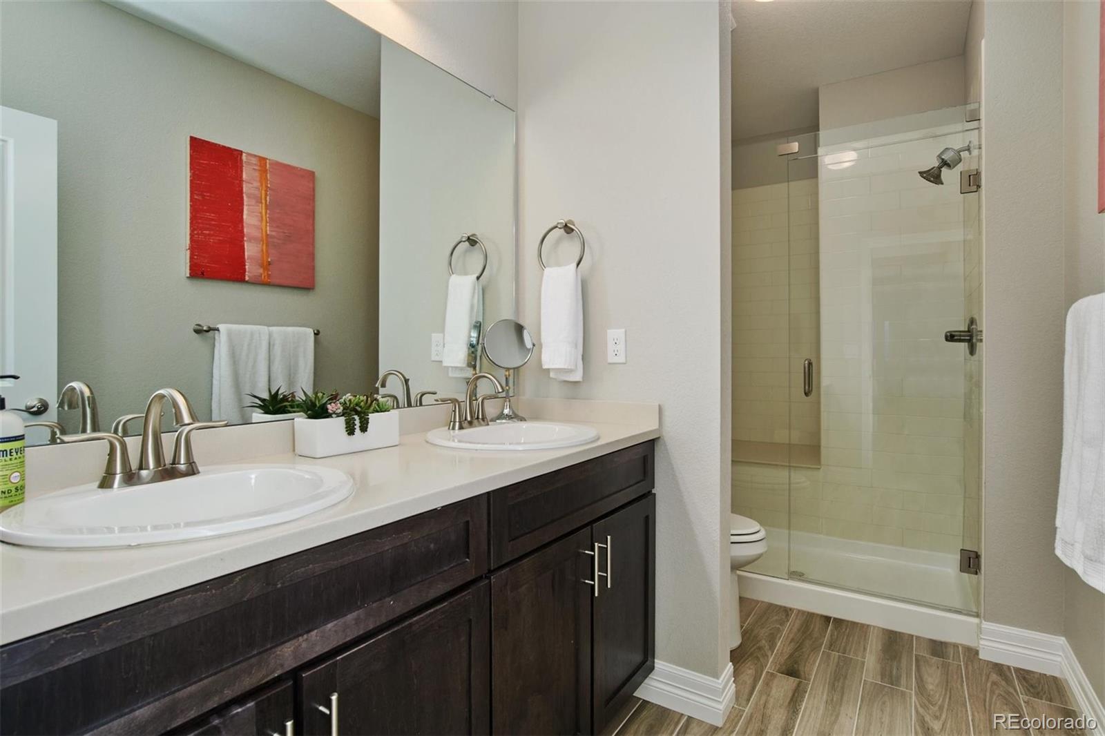 4907 Hogback Ridge Road Morrison, CO 80465 - Photo 31 of 40 a bathroom with a sink a toilet and shower