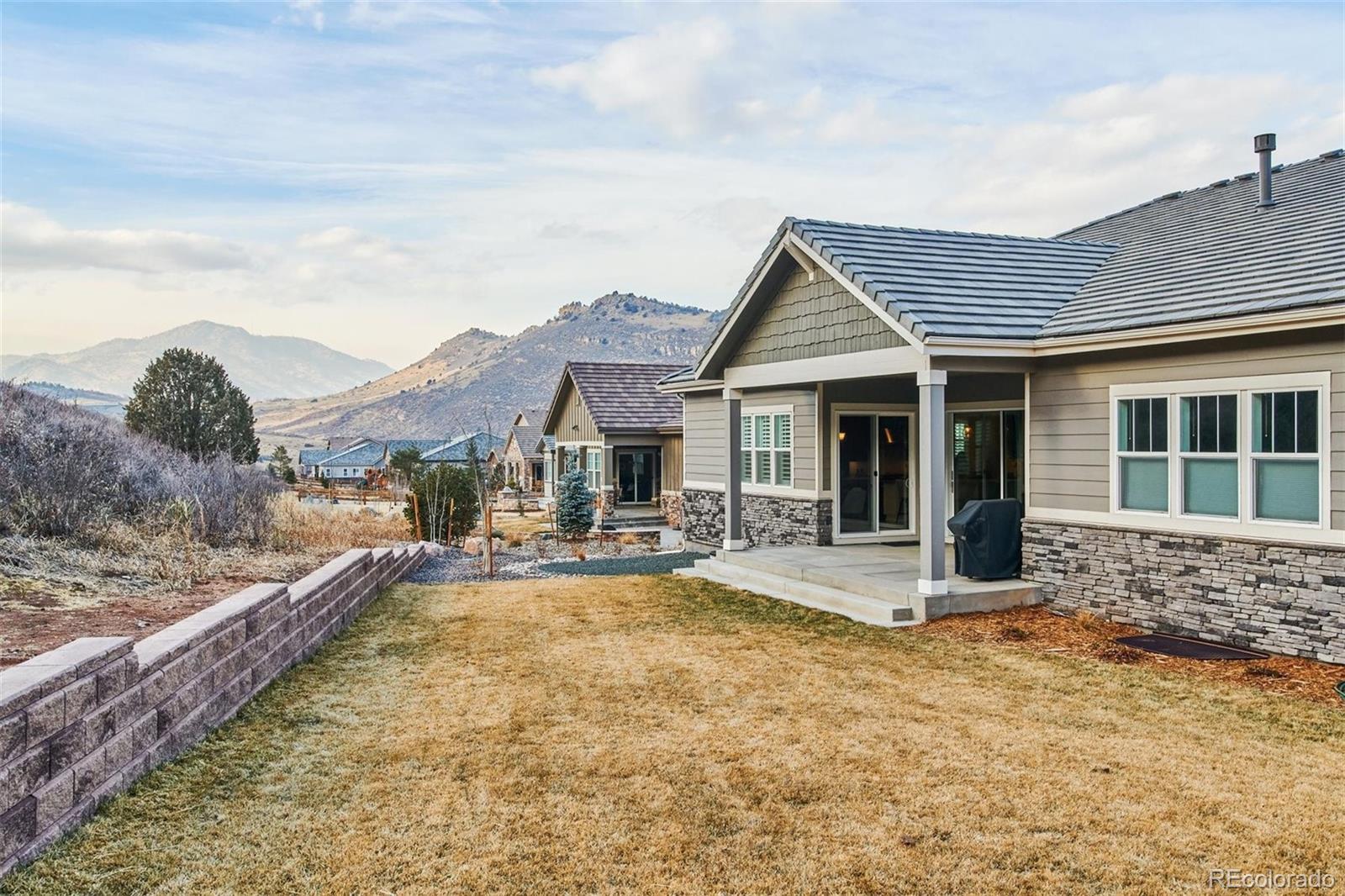 4907 Hogback Ridge Road Morrison, CO 80465 - Photo 38 of 40 a front view of house with yard outdoor seating and barbeque oven