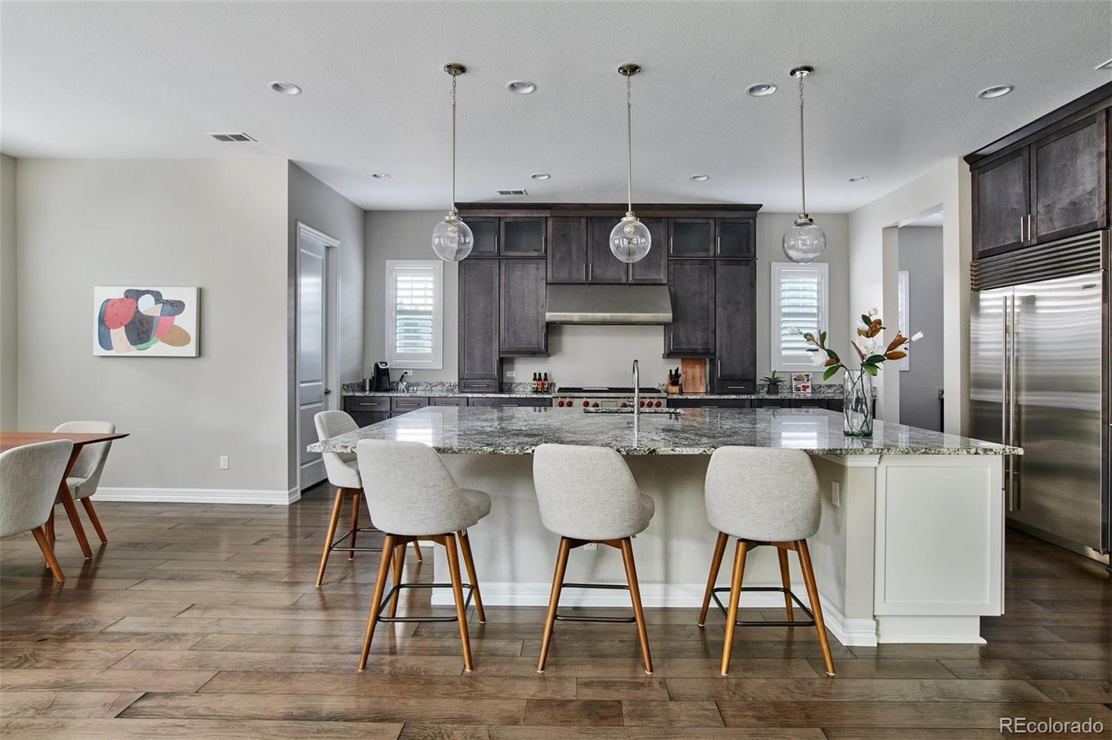 4907 Hogback Ridge Road Morrison, CO 80465 - Photo 8 of 40 a large kitchen with a table and chairs
