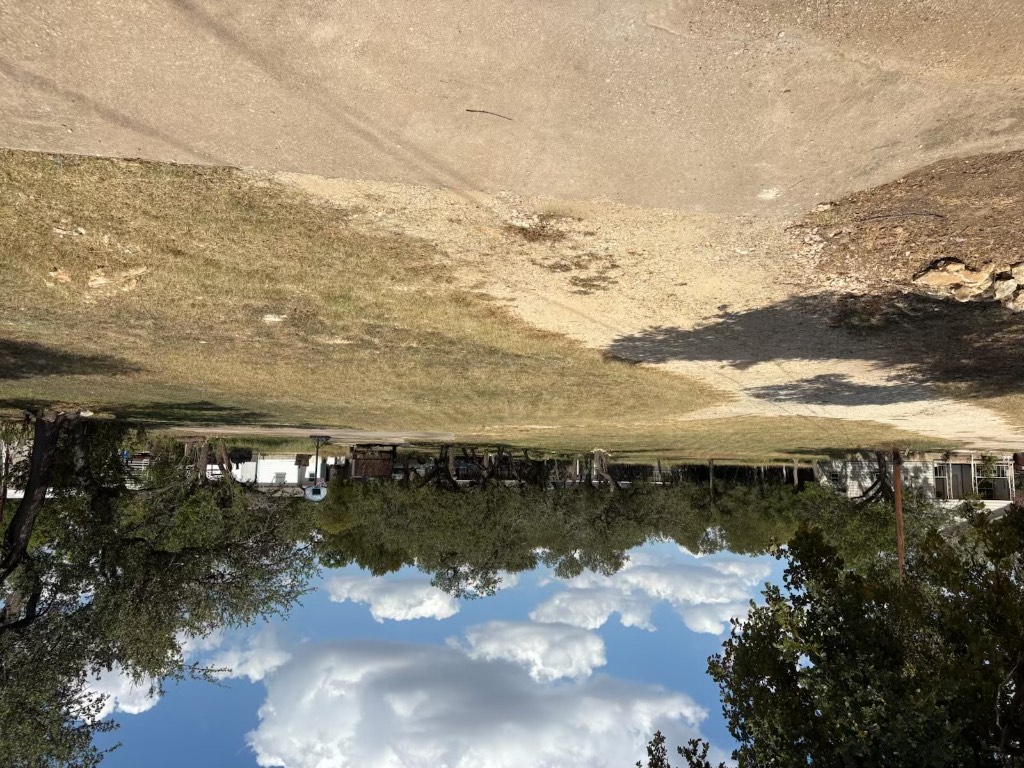 a view of outdoor space with swimming pool and green space