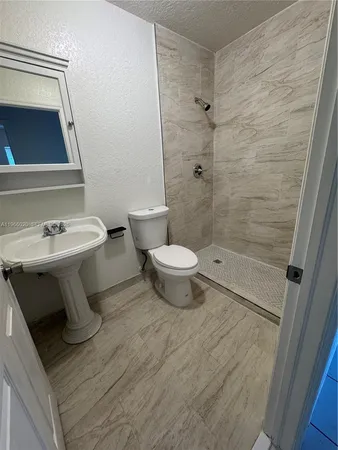 a bathroom with a sink toilet and shower