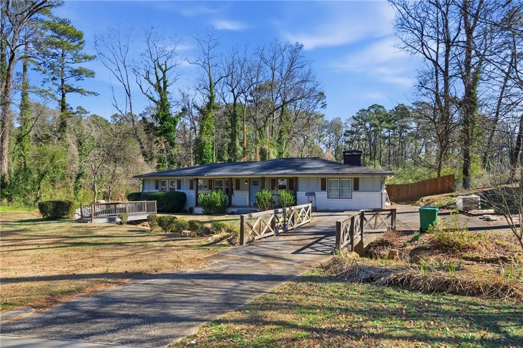 a view of a house with backyard and sitting area